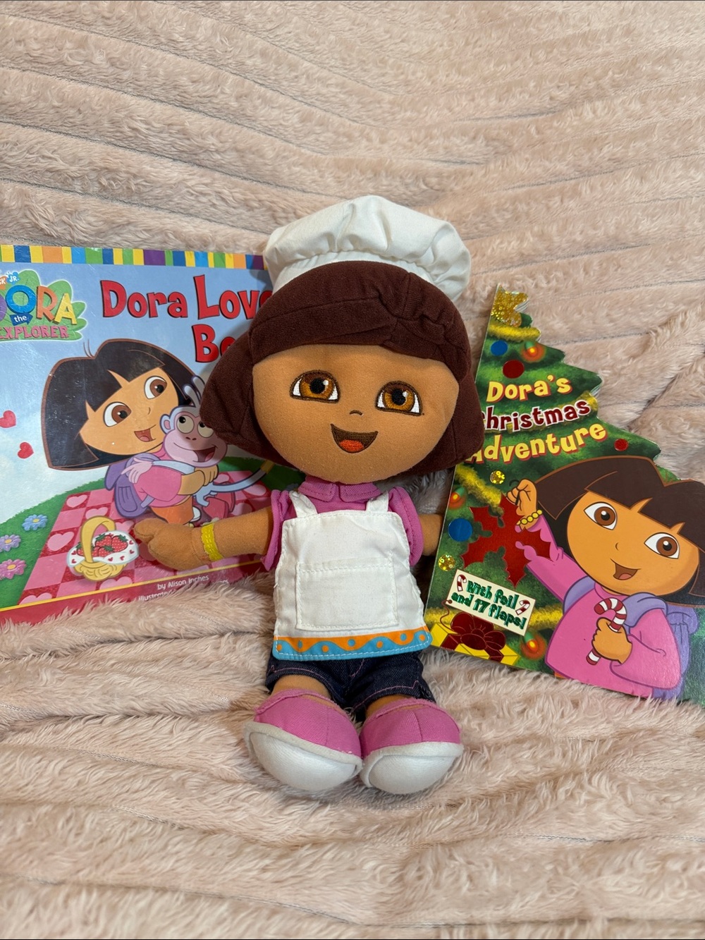 Dora plush and 1 paperback and 1 hardcover flap book
